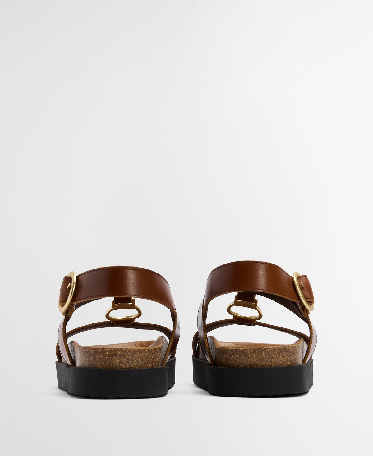 Pair of brown sandals with straps on a light gray background