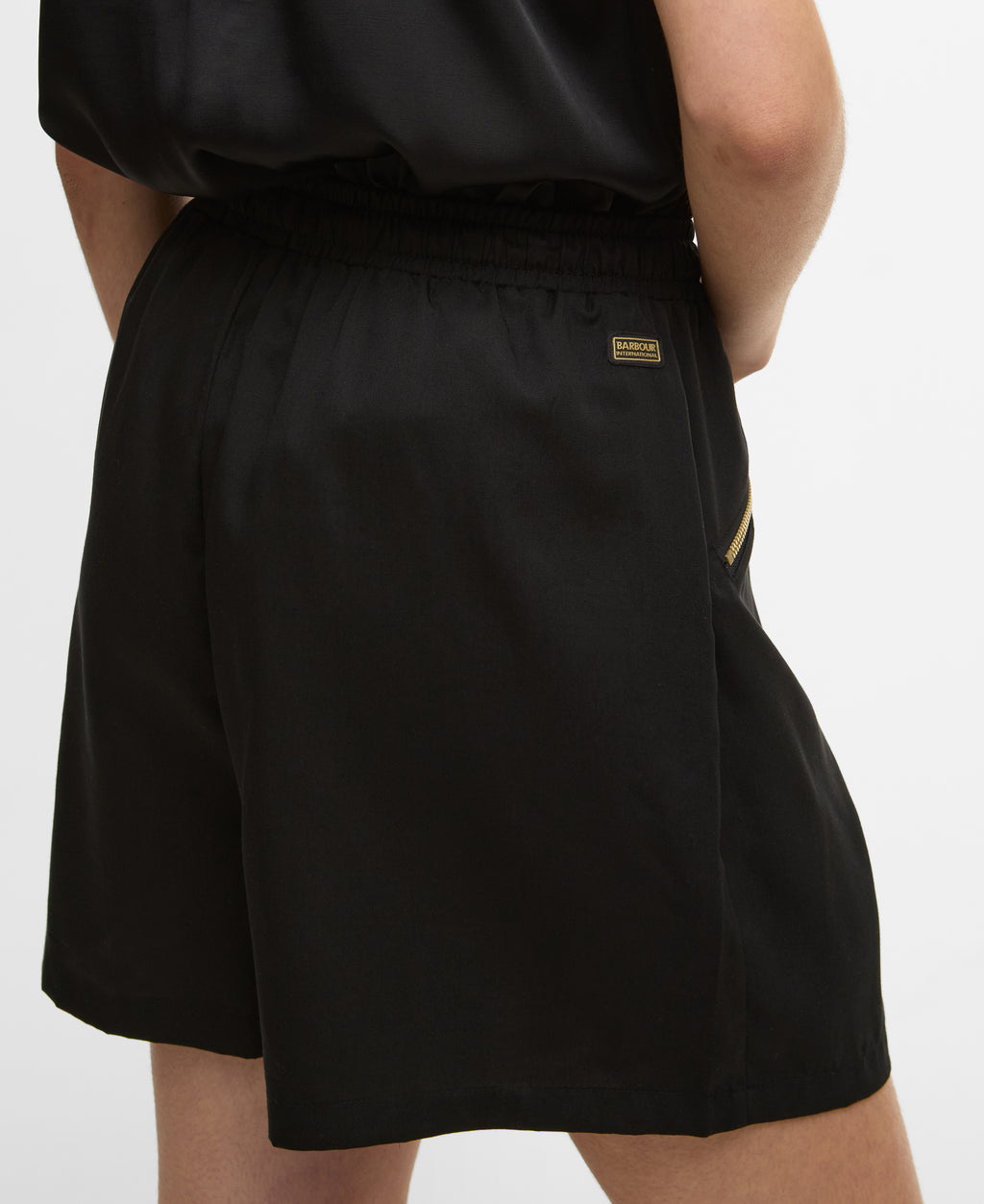 Black shorts with a brand logo on a white background