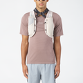 Person wearing a mauve t-shirt with a Salomon hydration backpack and bandana on a white background