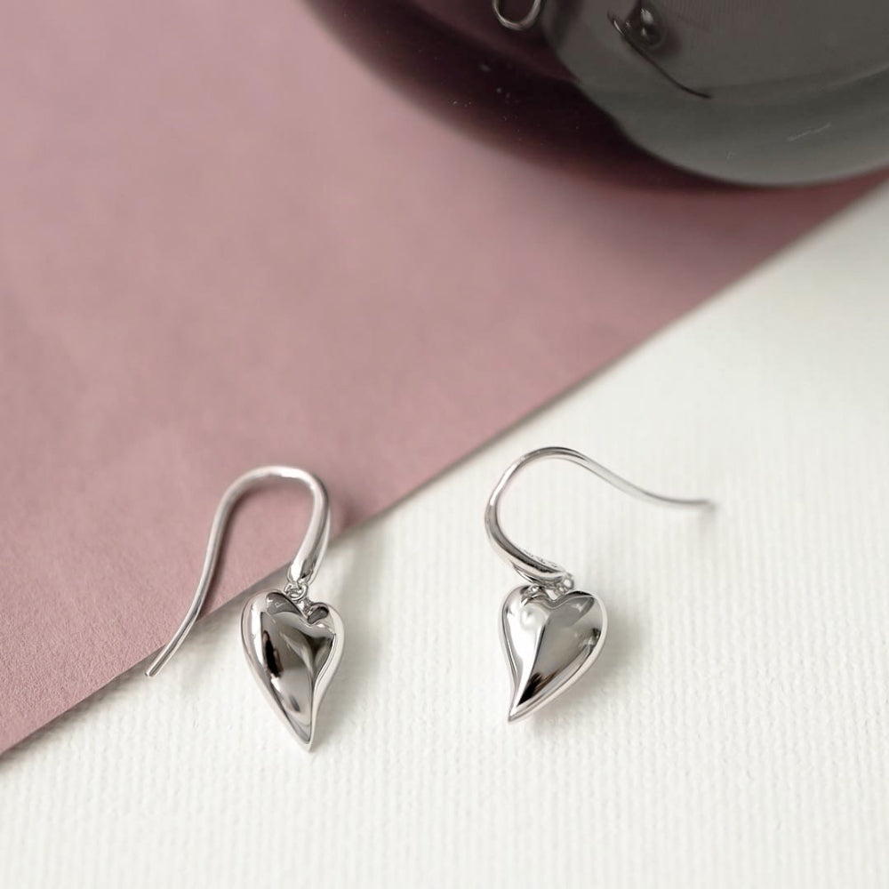 The Kit Heath Desire Cherish drop heart stud earrings, a silver metal earrings from Kit Heath, available at OD’s Jewellers in St Helens