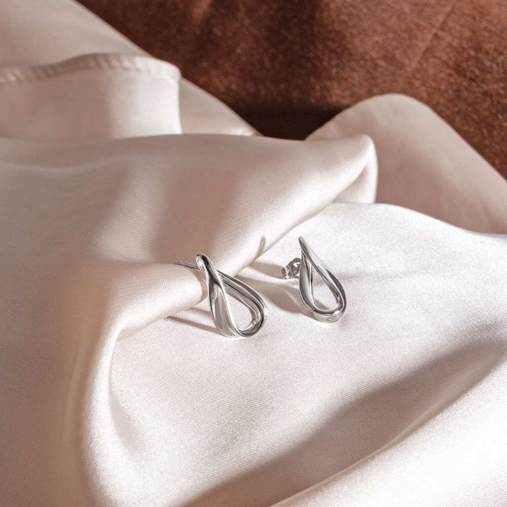 The Kit Heath Serenity Loop Grande Stud Earrings, a silver metal earrings from Kit Heath, available at OD’s Jewellers in St Helens