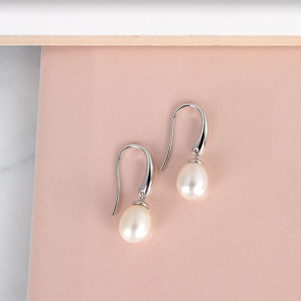 The Kit Heath Revival Classic Pearl Drop Earring, a silver pearl drop earring from Kit Heath, available at OD’s Jewellers in St Helens