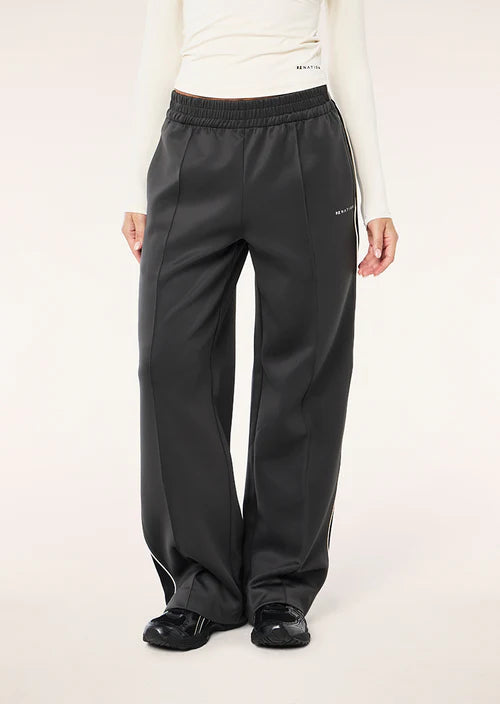 Person wearing black pants with a white background