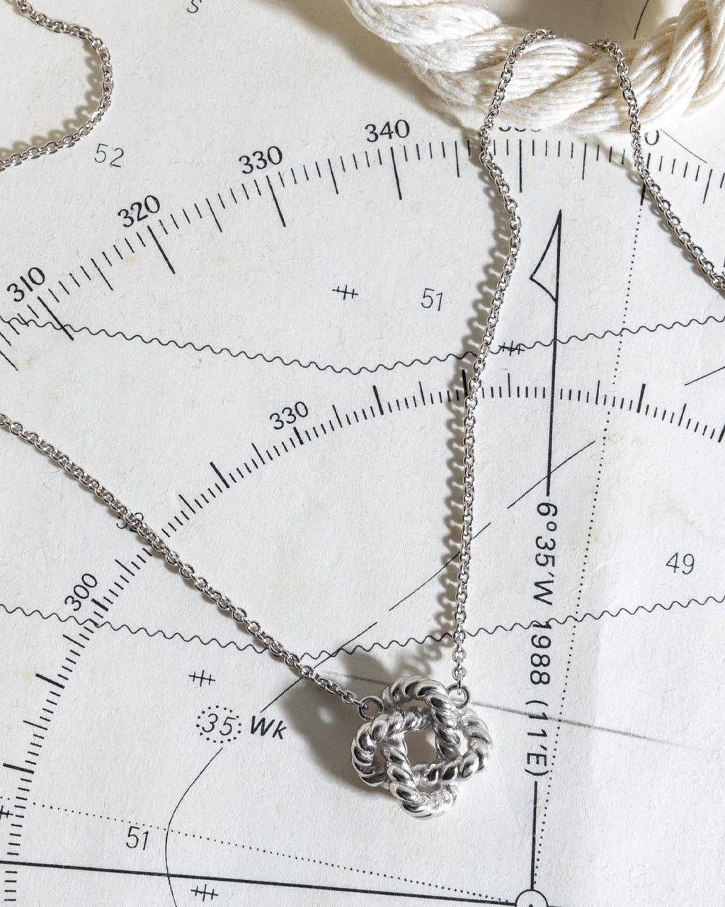 Marina Rope Knot Necklace on a styled background