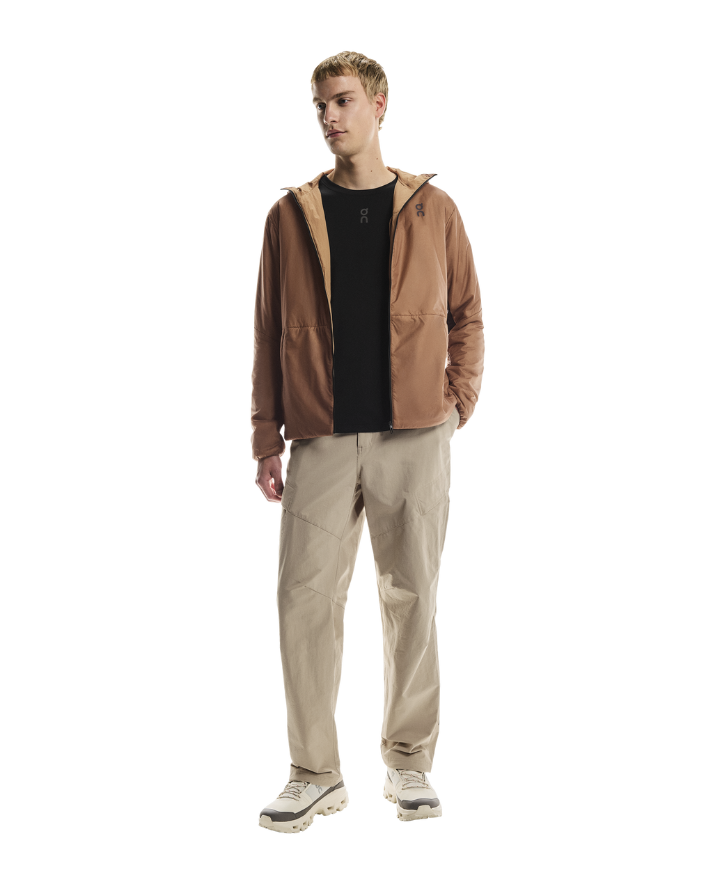 MAN WEARING Men's On Running Desert Water Resistant Trek Pants with matching on running jacket