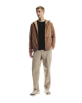 MAN WEARING Men's On Running Desert Water Resistant Trek Pants with matching on running jacket