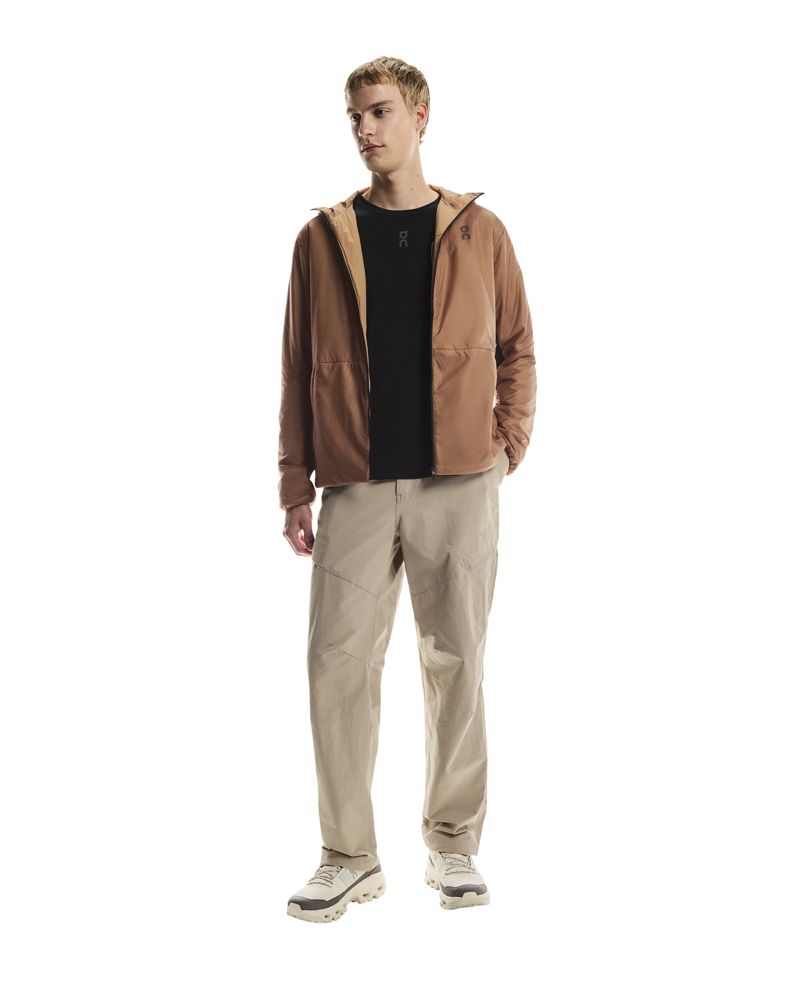 MAN WEARING Men's On Running Desert Water Resistant Trek Pants with matching on running jacket