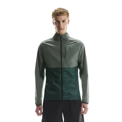 Man wearing a two-tone olive jacket with chest zip pocket on on chest logo with a white background