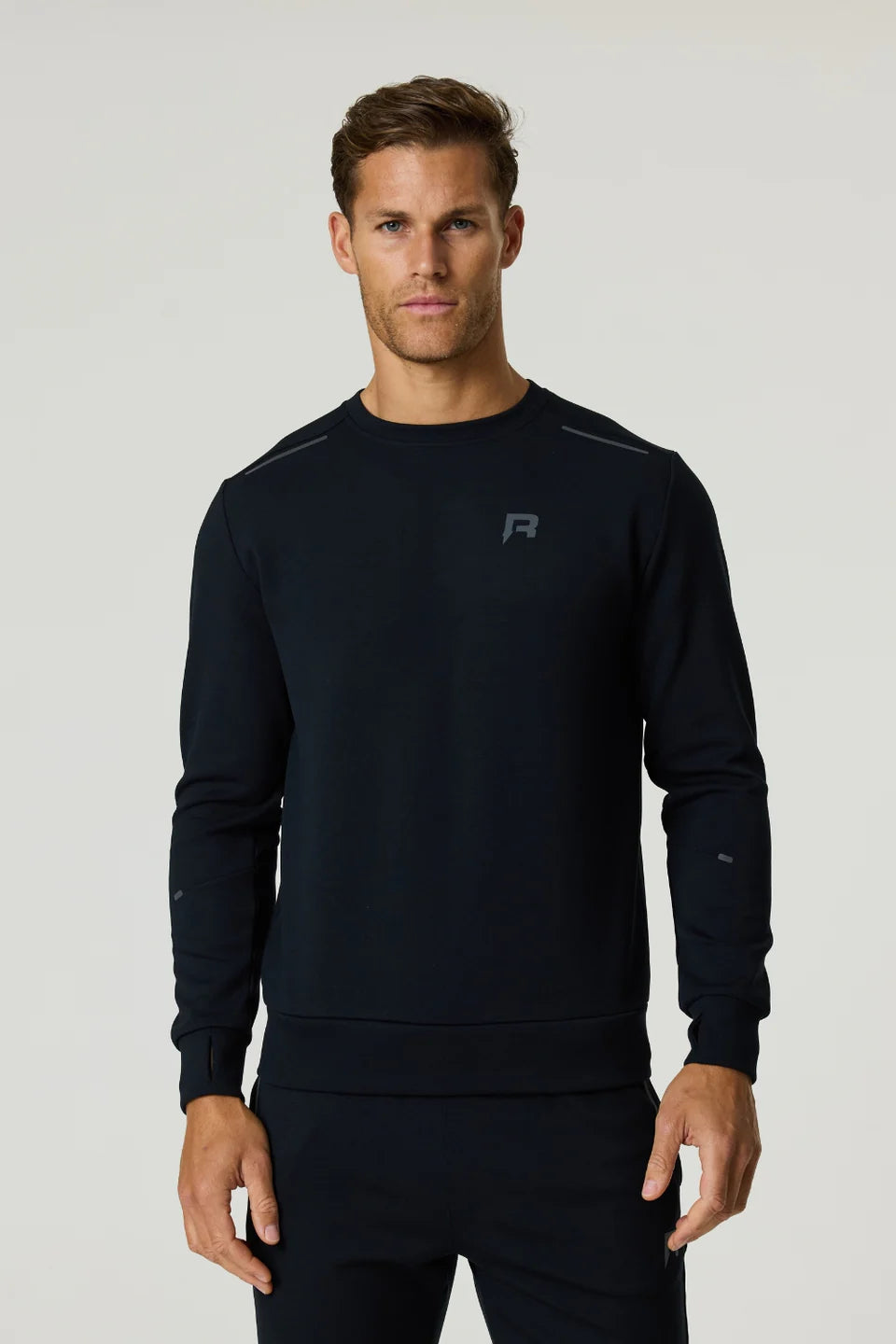 Men's Reprimo Black Motion Crew Neck Jumper with chest reflective logo and reflective strips styled with matching tracksuit pant