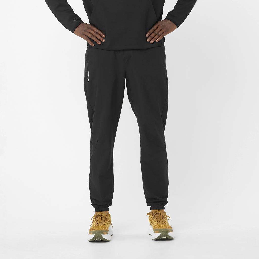 Men's Salomon Black SHKout Core Pants model image with matching salomon trainers