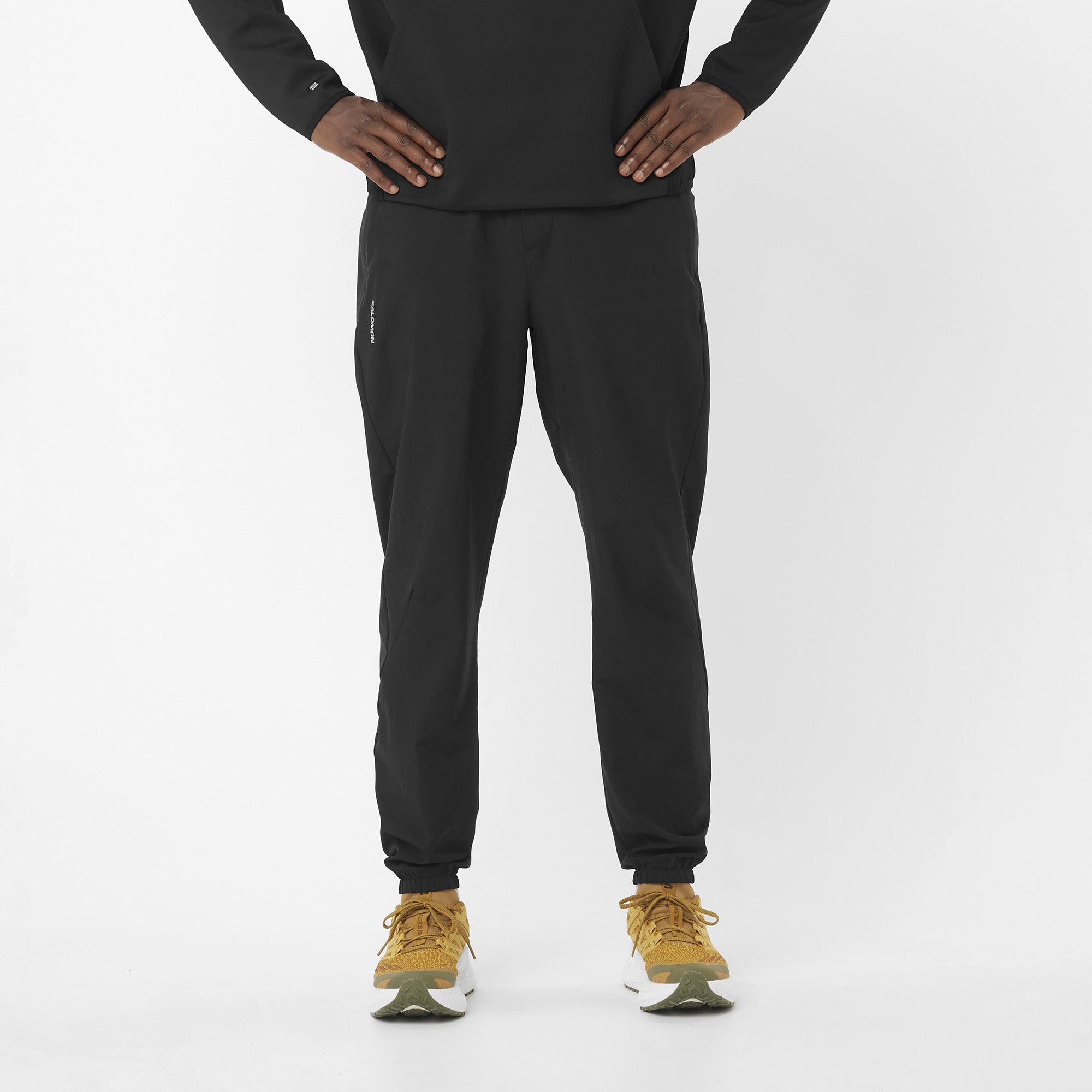 Men's Salomon Black SHKout Core Pants model image with matching salomon trainers