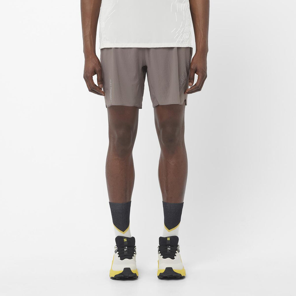 Men's Salomon Iron Sense Aero 7'' Shorts with reflective logos and branding. styled with matching salomon shoes and t shirt 