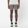 Men's Salomon Iron Sense Aero 7'' Shorts with reflective logos and branding. styled with matching salomon shoes and t shirt 