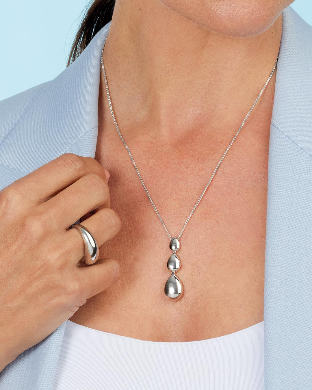 Model wears Coast Pebble Smooth Triple Grande Toggle Necklace