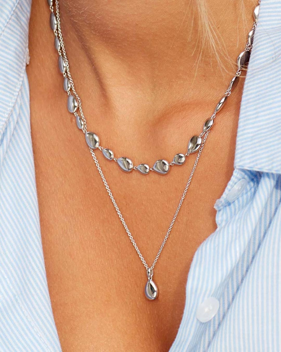 Model wears Pebbles Droplet Necklace