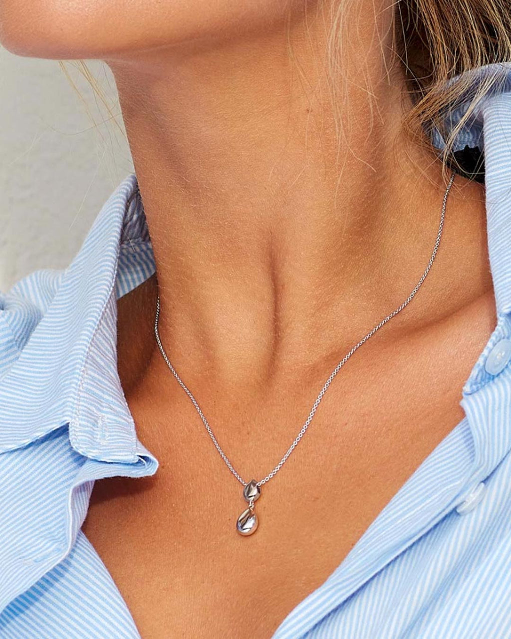 Model wears Pebbles Twin Droplet Necklace