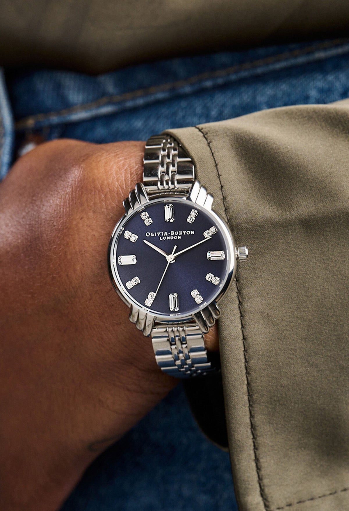 Olivia Burton Art Deco watch on wrist. Navy dial, stainless steel bracelet.