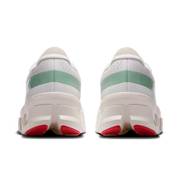 White sneakers with green accents and red soles on a white background