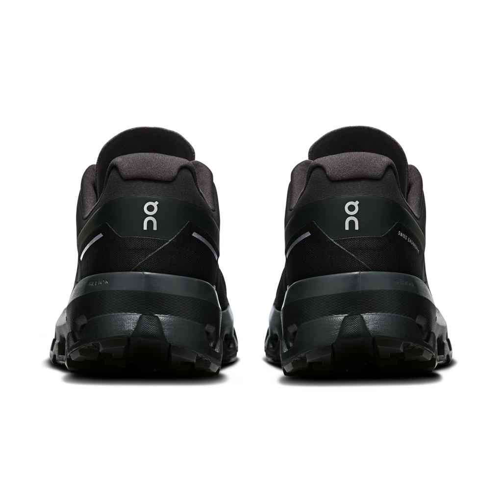 Black athletic shoes with a brand logo on a transparent background