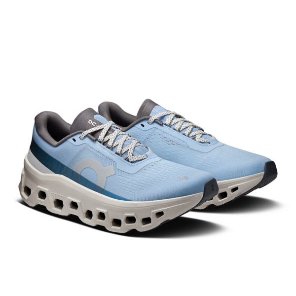 Pair of blue running shoes with white soles on a white background
