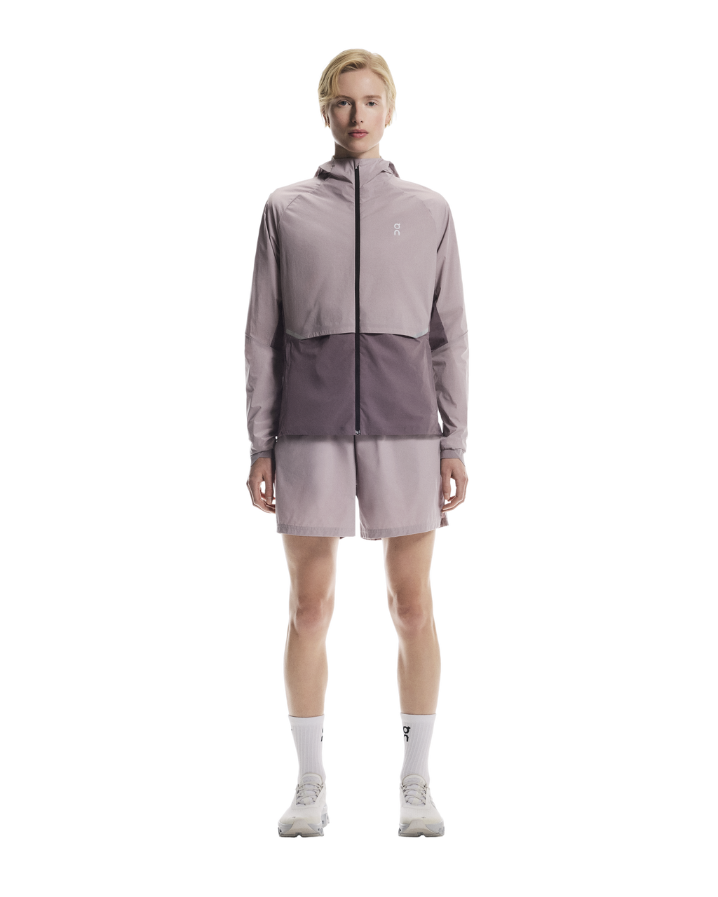 Person wearing a two-tone jacket on a white background