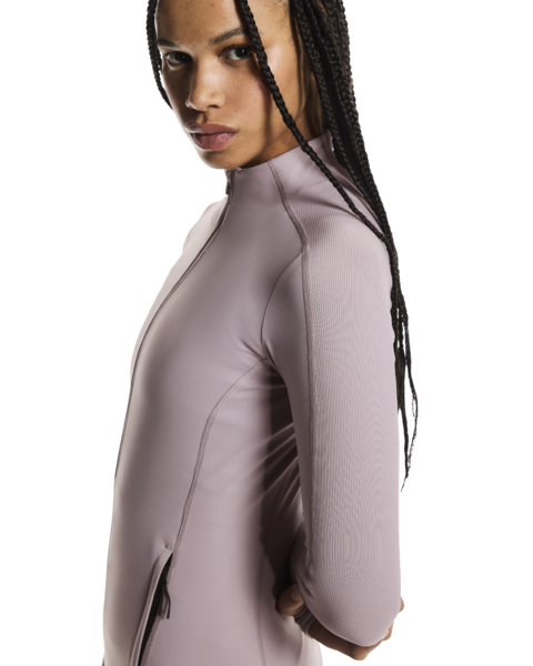 Woman wearing a light purple long-sleeve top on a white background