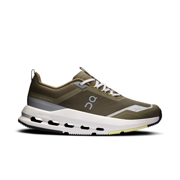 Green running shoe with white sole on a white background