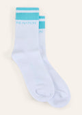 Light blue socks with turquoise accents on a beige background