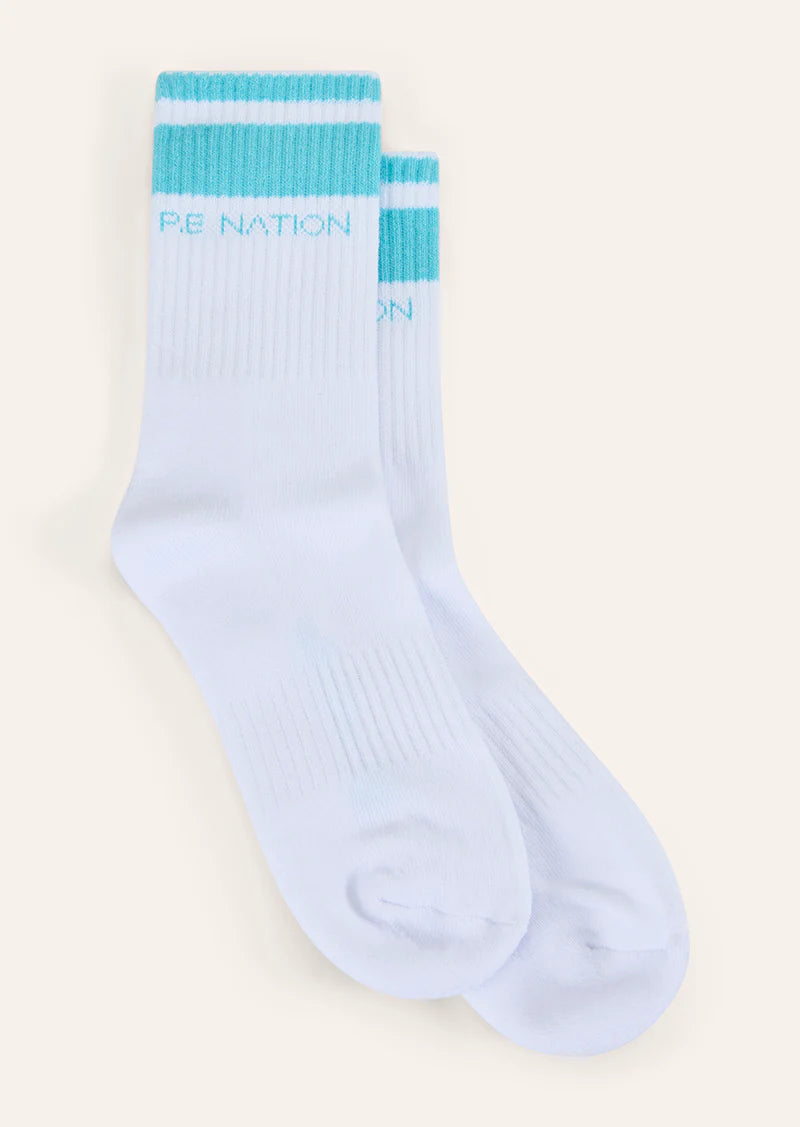 Light blue socks with turquoise accents on a beige background