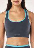 Gray sports bra with blue trim worn by a person on a white background