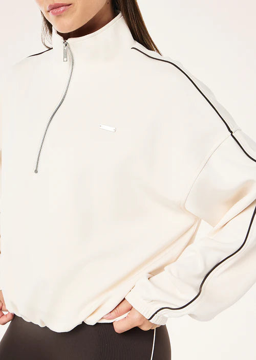 White jacket with black accents worn by a person on a white background
