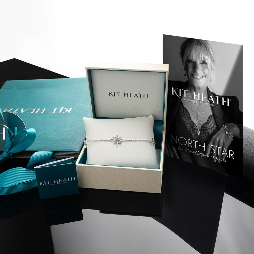 Product shot of Kit Heath jewelry gift set including a bracelet, box, ribbon, and promotional catalog.