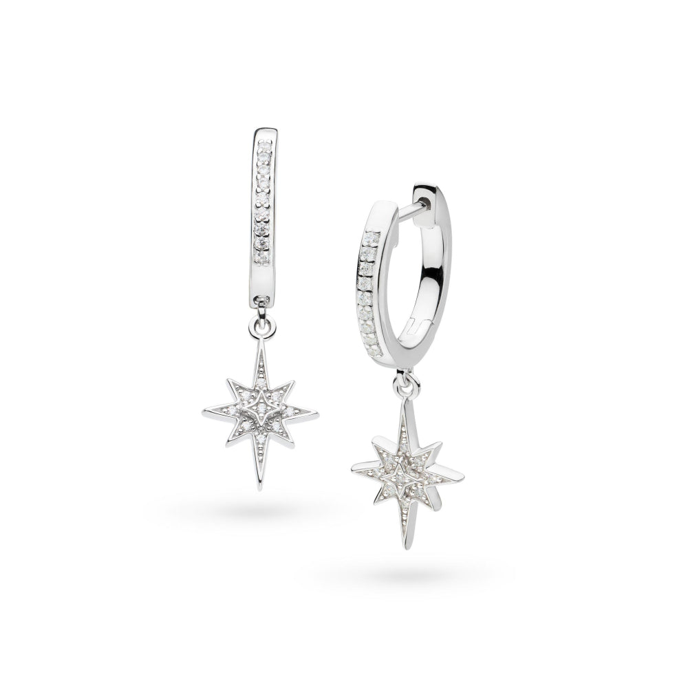 Two silver, diamond-studded hoop earrings with star pendants.