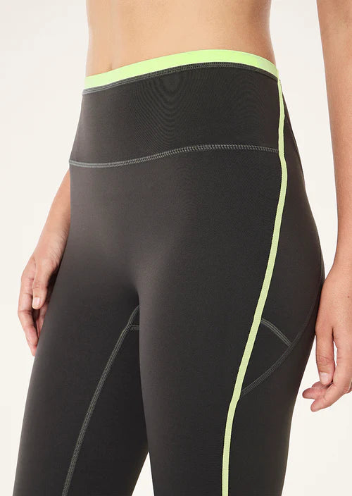 Grey leggings with neon green accents on a white background