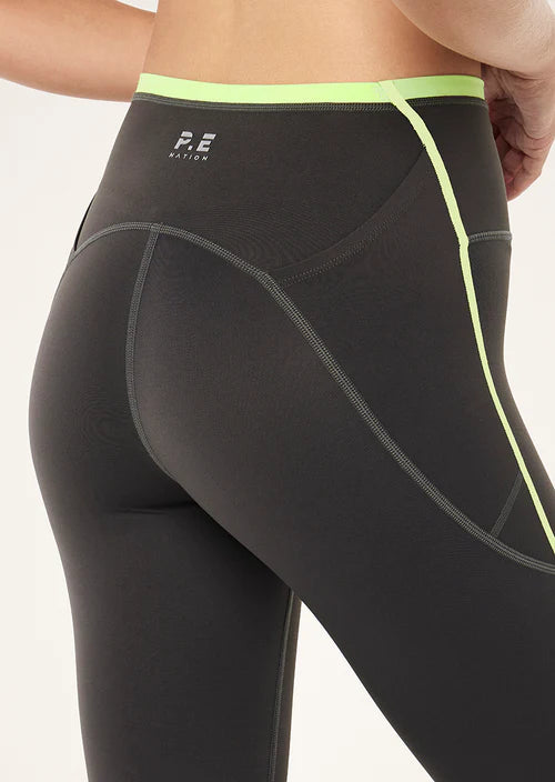 Grey leggings with neon green accents on a white background