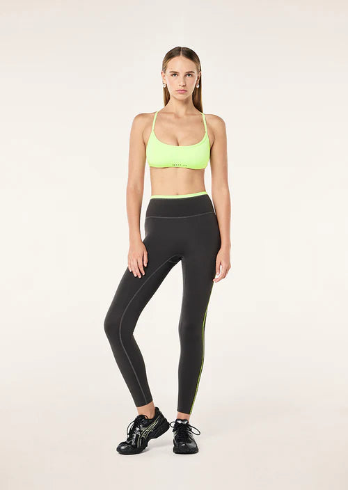 Grey leggings with neon green accents on a white background
