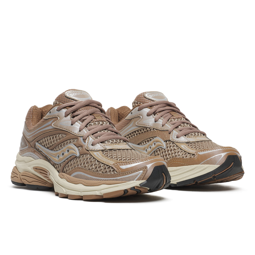A pair of Saucony athletic sneakers in a warm taupe and beige colorway, featuring mesh panels, synthetic overlays, and a chunky midsole, shown against a plain white background.