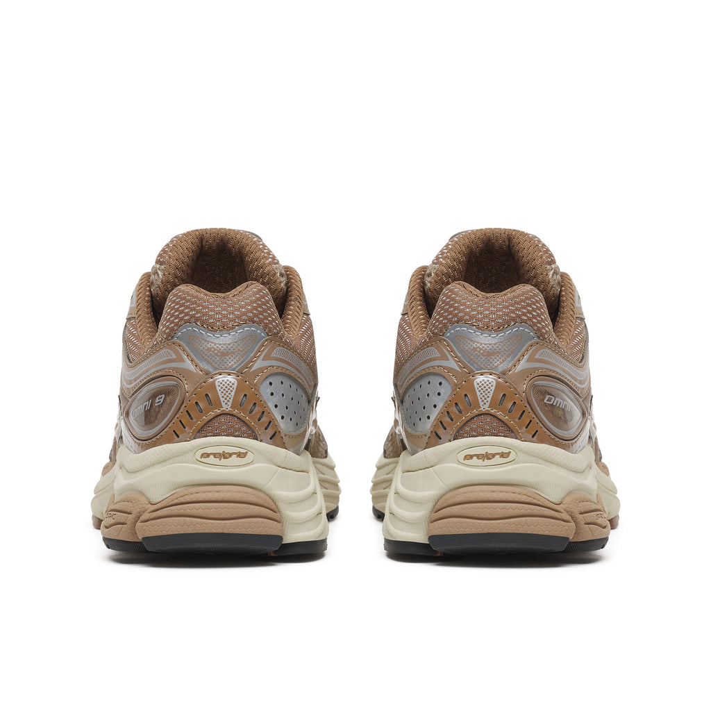 A pair of vintage Nike Air Max sneakers shown from the back, featuring a brown mesh upper with metallic silver overlays and a beige and cream midsole.
