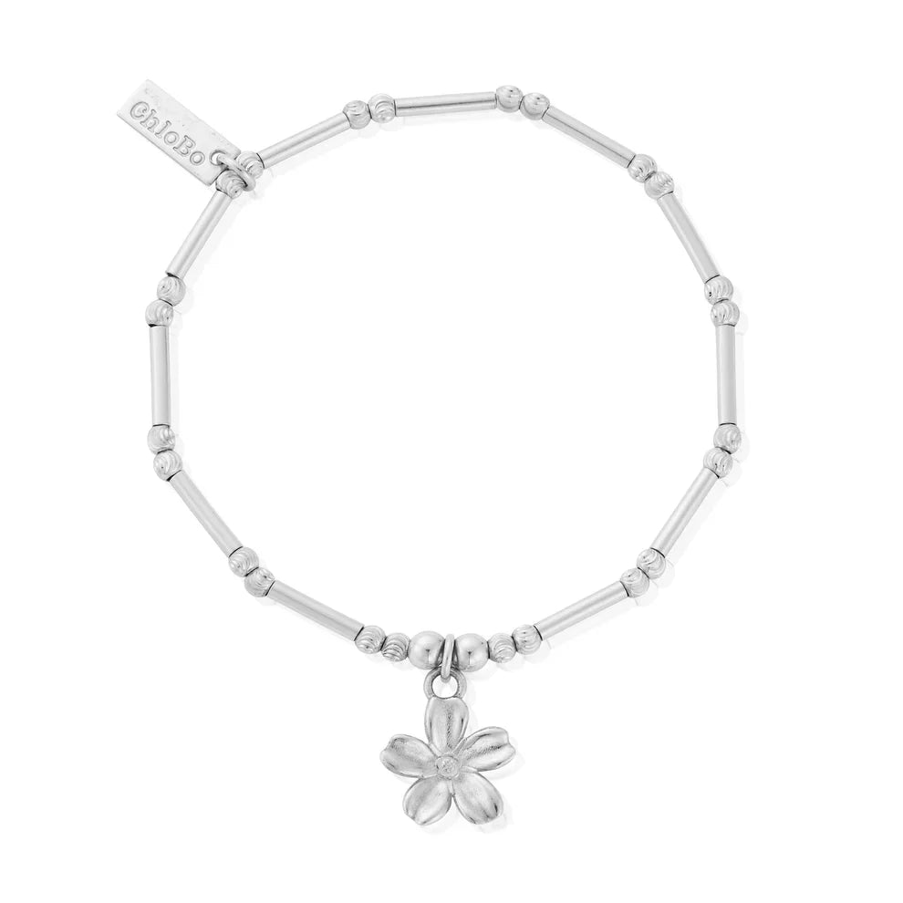 Silver bracelet with flower charm.