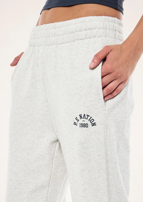 White sweatpants with 'P.E. Nation' logo on a plain background