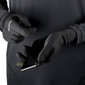 Person wearing Salomon gloves using a phone with a black background