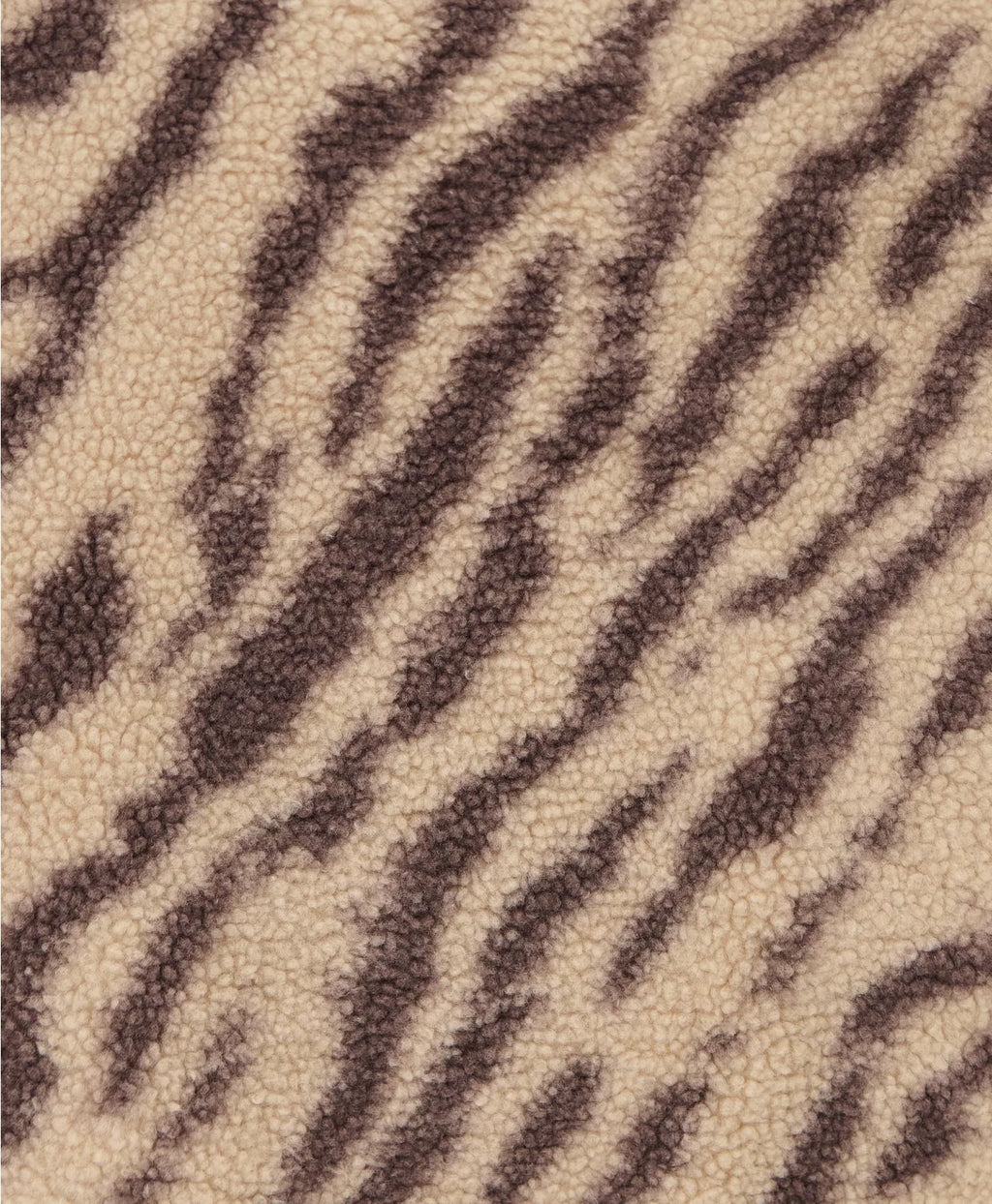 Textured fabric with a zebra stripe pattern in brown and beige.