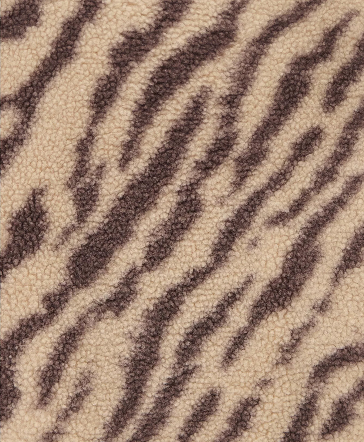Textured fabric with a zebra stripe pattern in brown and beige.