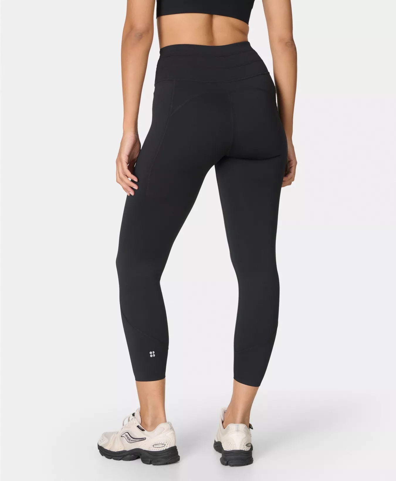 Person wearing black leggings on a white background