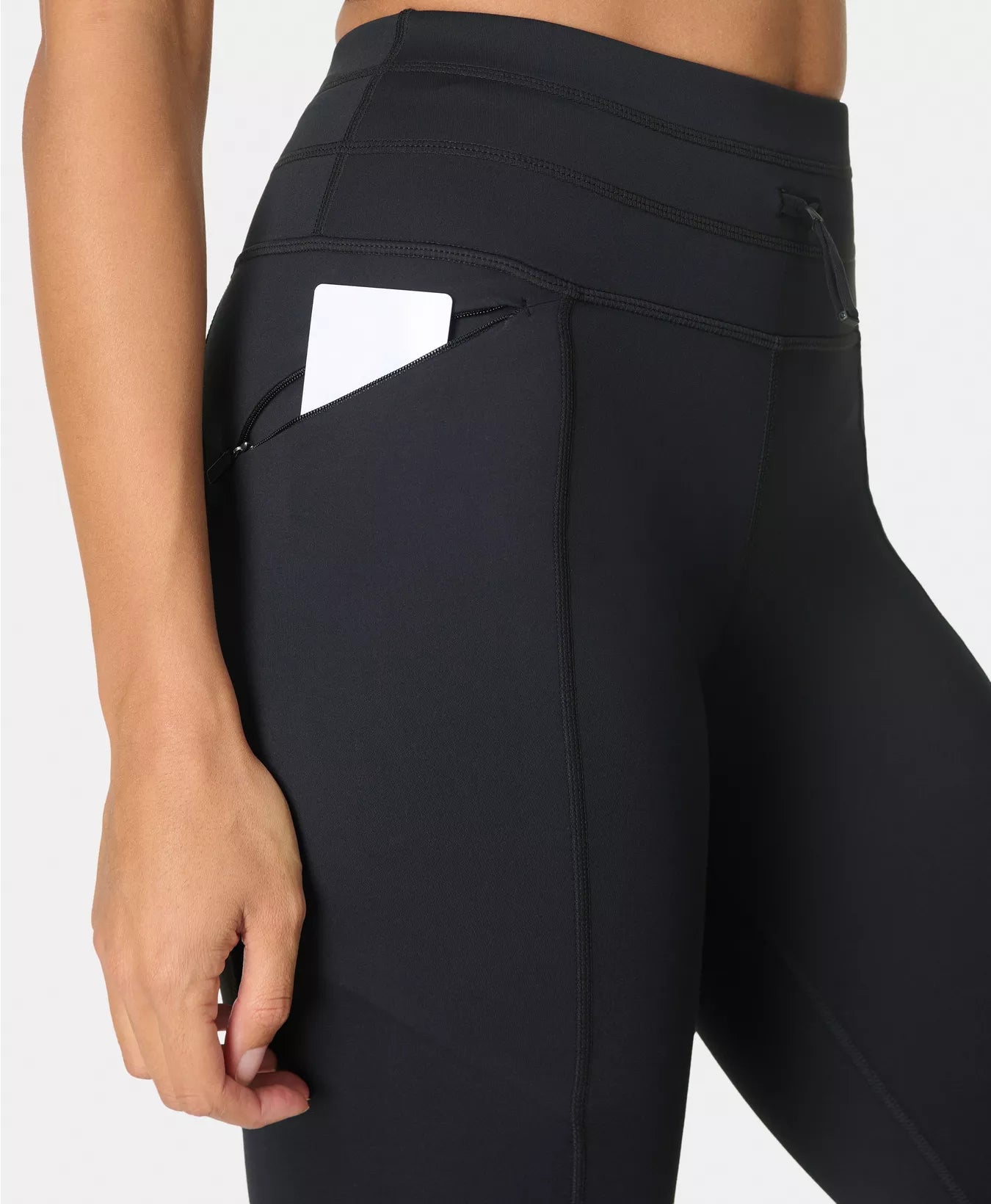 Black leggings with a focus on the waistband and pocket design.