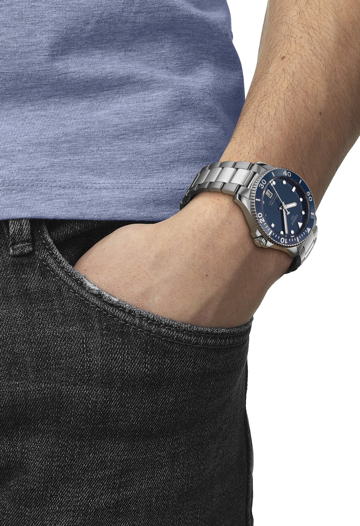 Tissot Seastar watch shown on wrist, highlighting size and wearability. Blue dial and stainless steel band are clearly