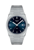 Close-up of Tissot PRX watch with blue dial & stainless steel bracelet. Tissot 1853 & PRX logos visible. Showcases watch