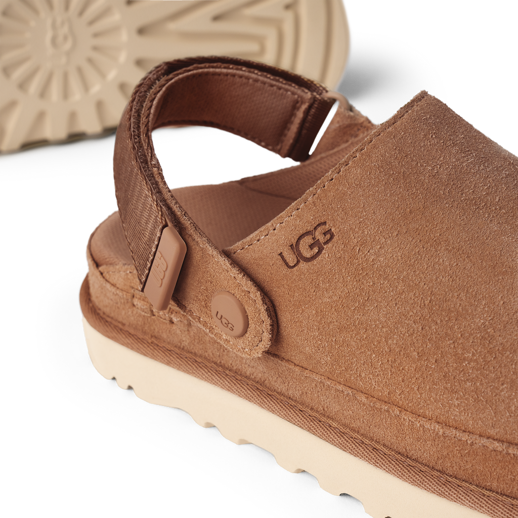 Brown UGG sandal with visible brand logo on a white background