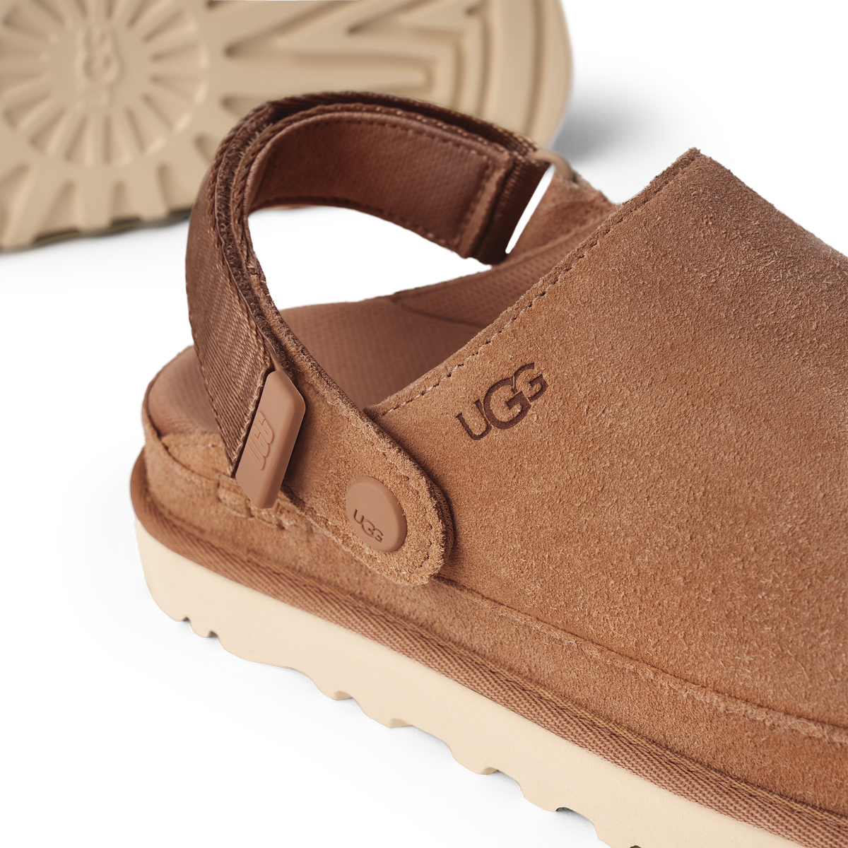 Brown UGG sandal with visible brand logo on a white background