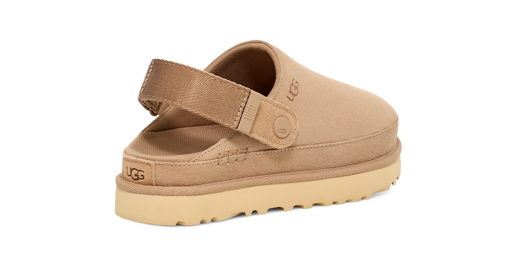 Beige UGG sandal with a strap on a white background